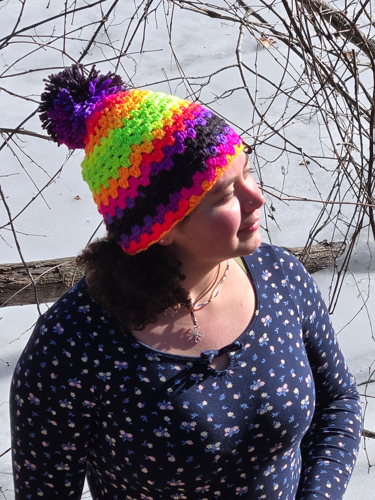 Crocheted multi colored beanie hat with pom